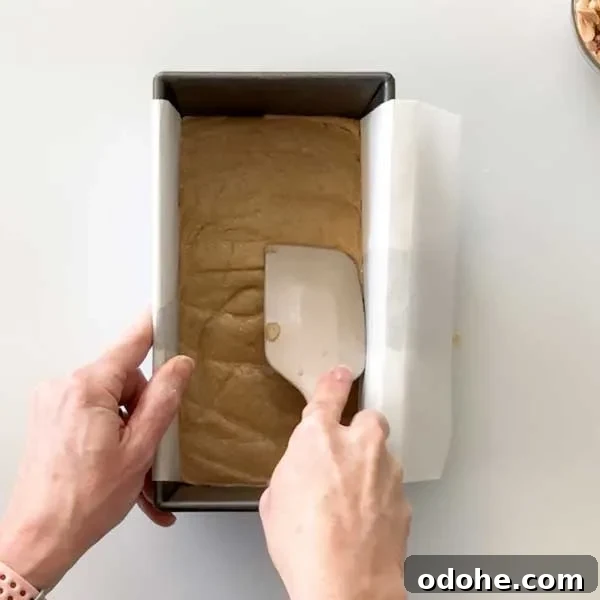 Gluten-Free Snickers Copycat Recipe: Homemade Chocolate Caramel Nougat 8 Spreading the cookie layer into the bottom of a parchment paper-lined bread pan.
