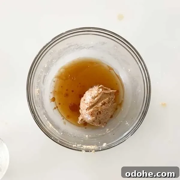 Gluten-Free Snickers Copycat Recipe: Homemade Chocolate Caramel Nougat 9 Adding the wet ingredients to a mixing bowl.