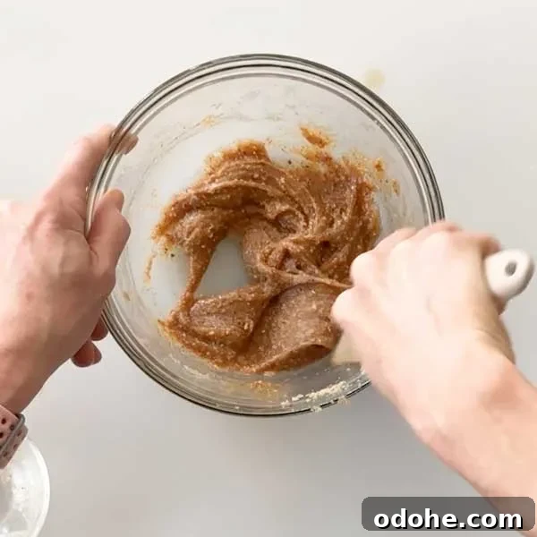 Gluten-Free Snickers Copycat Recipe: Homemade Chocolate Caramel Nougat 10 Mixing the almond butter caramel layer together with a whisk in a mixing bowl.