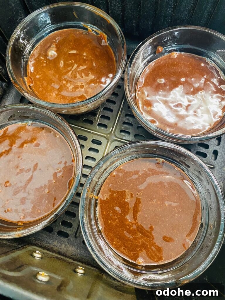 Molten Chocolate Lava Cakes for the Air Fryer 5 lava cakes in bowls in the air fryer before cooking