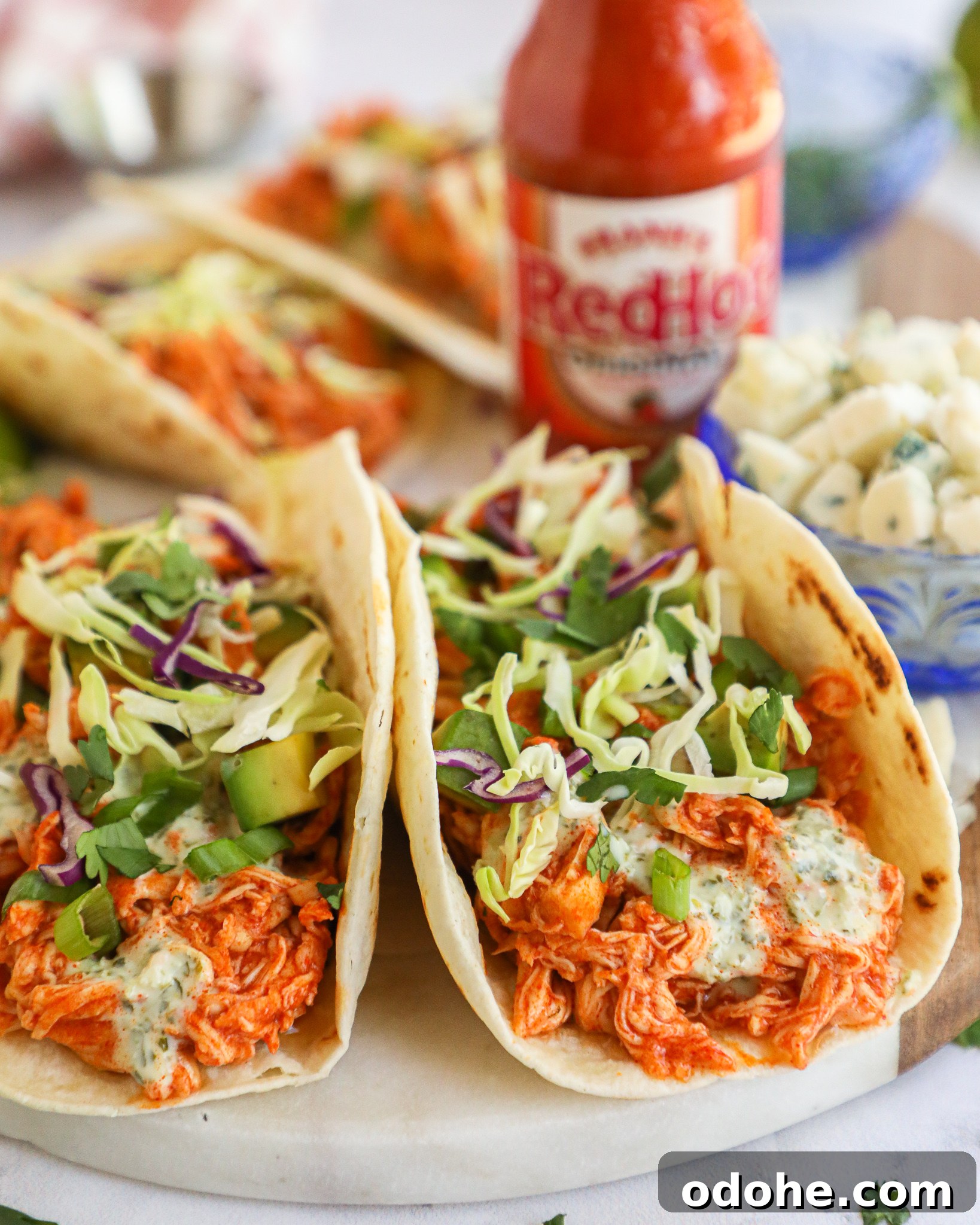 Baked Buffalo Chicken Tacos with Cilantro-Lime Crema 7 Easy, healthy and delicious! These baked buffalo chicken tacos have just the right amount of heat and are perfect for taco night!