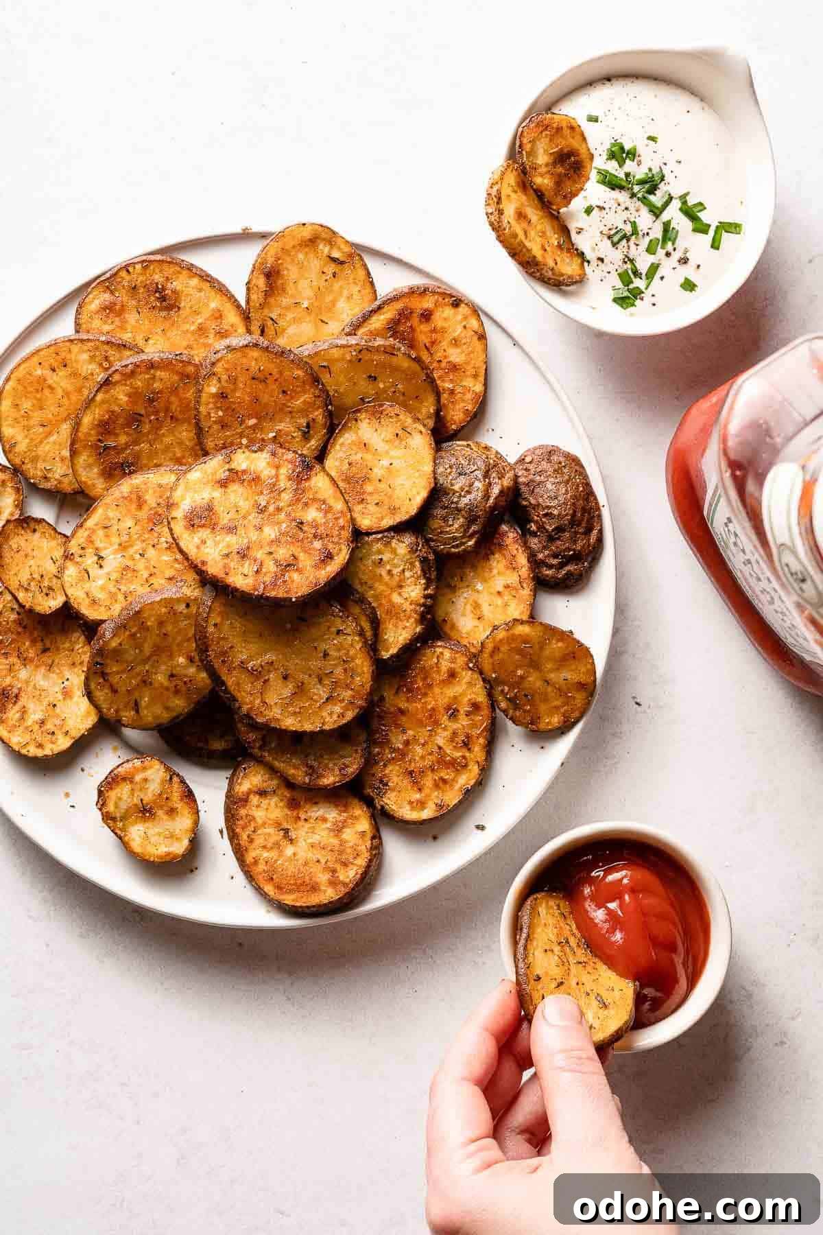 Crispy Cottage Fries Recipe: Homemade Seasoned Potato Wedges 2 plate of cottage fries with hand dipping one in ketchup