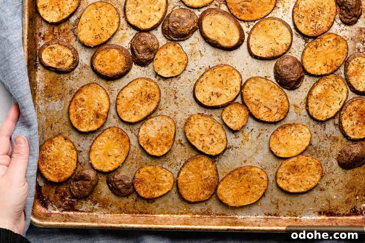 Crispy Cottage Fries Recipe: Homemade Seasoned Potato Wedges 11 cooked cottage fries on metal baking sheet