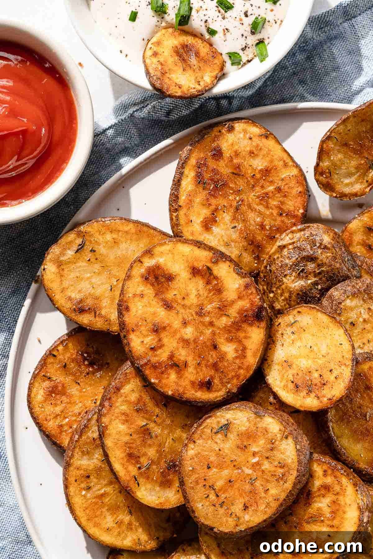 Crispy Cottage Fries Recipe: Homemade Seasoned Potato Wedges 12 cottage fries on white plate with ketchup and ranch dressing on the side