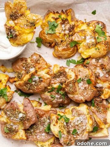 smashed potatoes in parchment paper with side of sour cream.