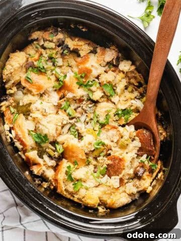 stuffing in crock pot with wooden spoon.