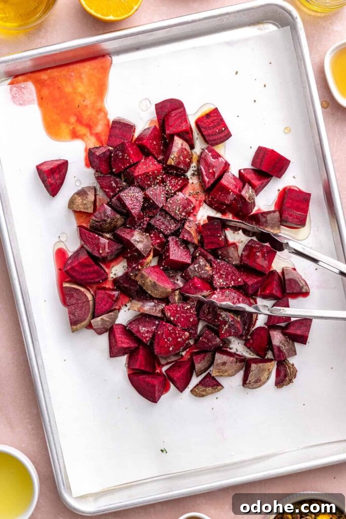 Roasted Beet Salad with Lemon Tahini Dressing and Pistachios 11 Fresh red beets chopped on a sheet pan for beet salad