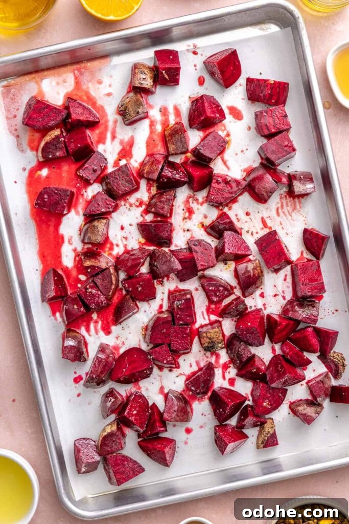 Roasted Beet Salad with Lemon Tahini Dressing and Pistachios 12 Seasoned beets on a parchment-lined baking sheet before roasting