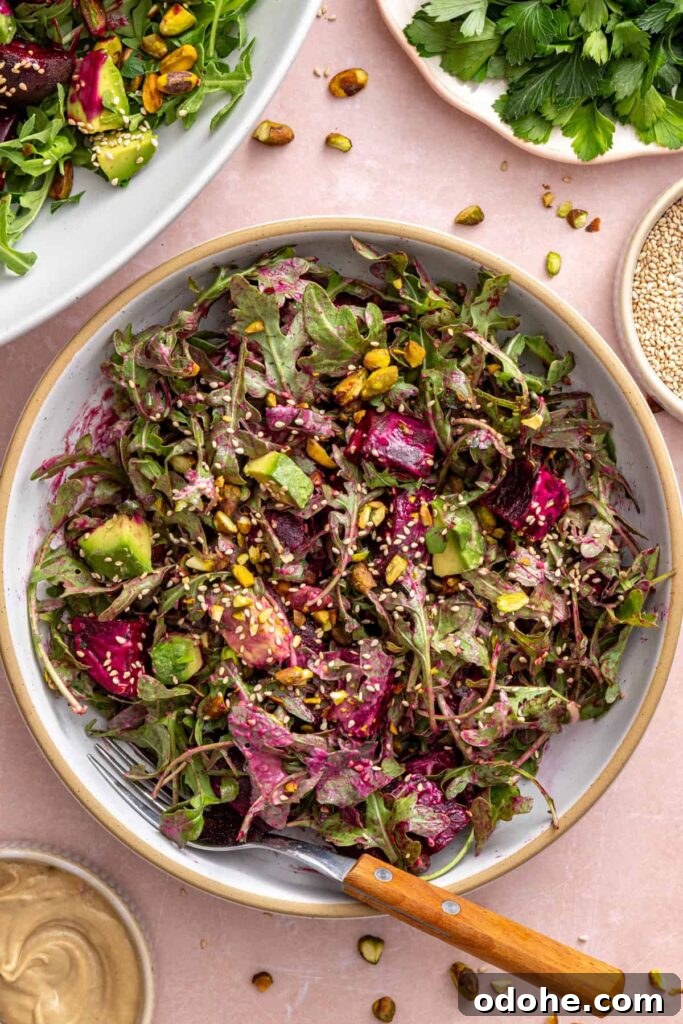Roasted Beet Salad with Lemon Tahini Dressing and Pistachios 13 Tossed roasted beet salad served in a bowl with a fork