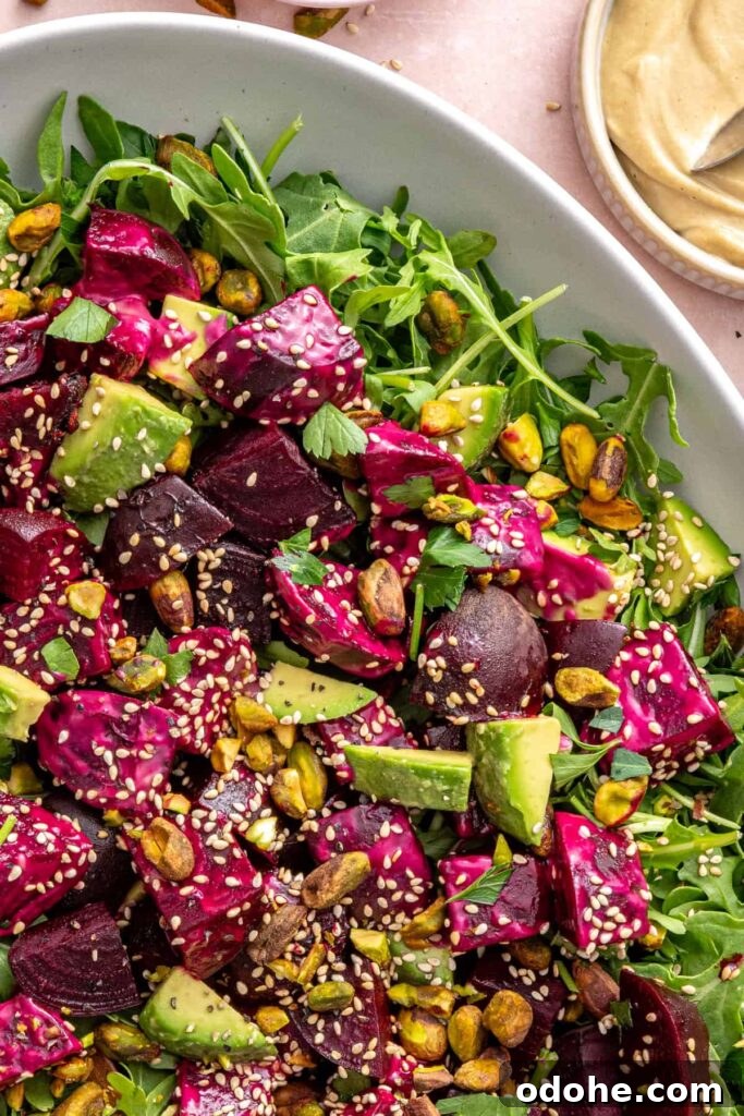 Roasted Beet Salad with Lemon Tahini Dressing and Pistachios 7 Overhead shot of beet salad with goat cheese and arugula on a serving platter