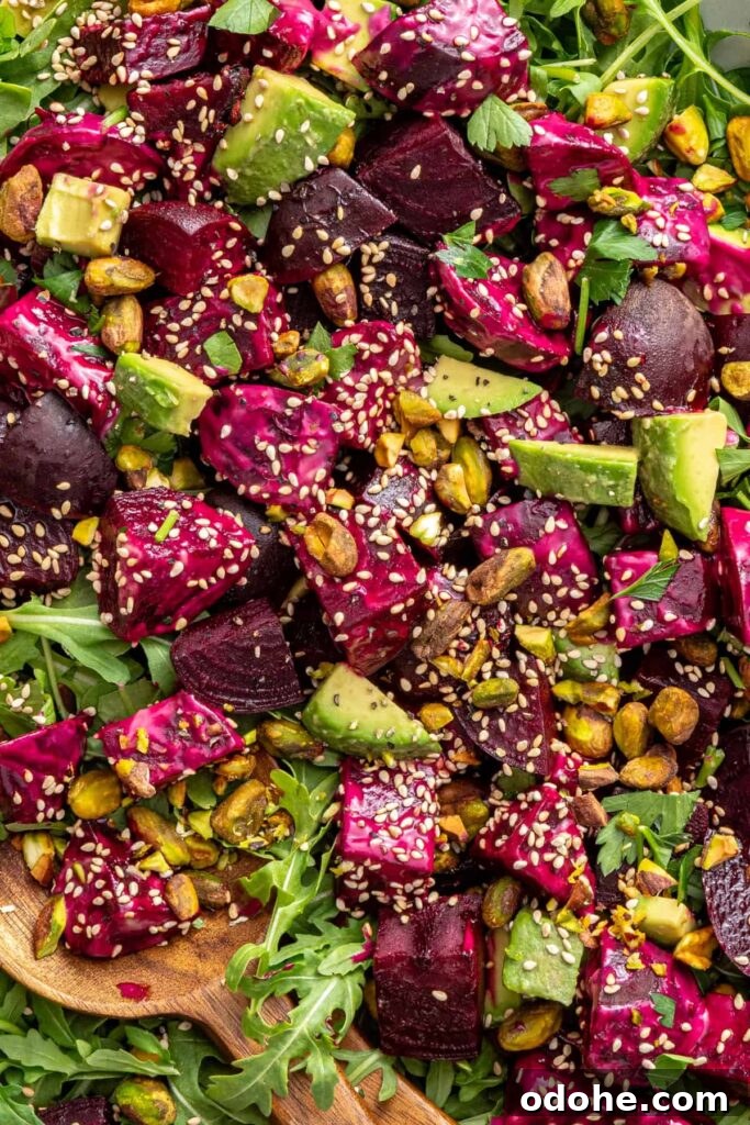 Roasted Beet Salad with Lemon Tahini Dressing and Pistachios 9 close-up texture shot of beet salad with goat cheese, avocados, sesame seeds and tahini dressing