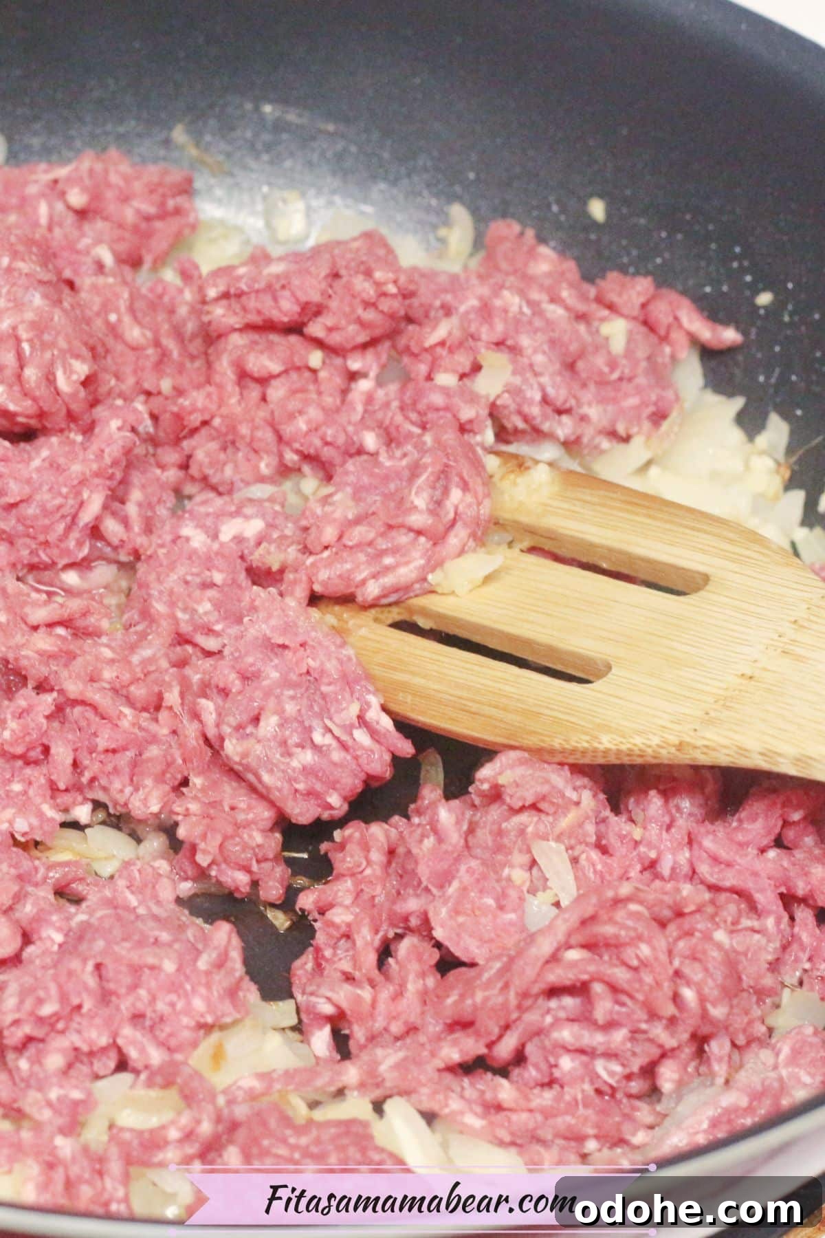 Gluten-Free Inside-Out Egg Roll Recipe: Crispy, Flavorful Wraps 5 Ground beef and onions with a wooden spoon in a skillet.
