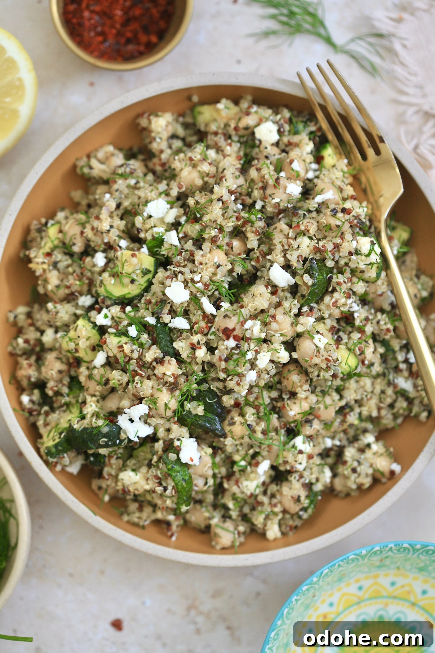 Zucchini, Quinoa & Chickpea Salad with Feta and Fresh Dill 2 bowl with quinoa salad and feta and gold fork