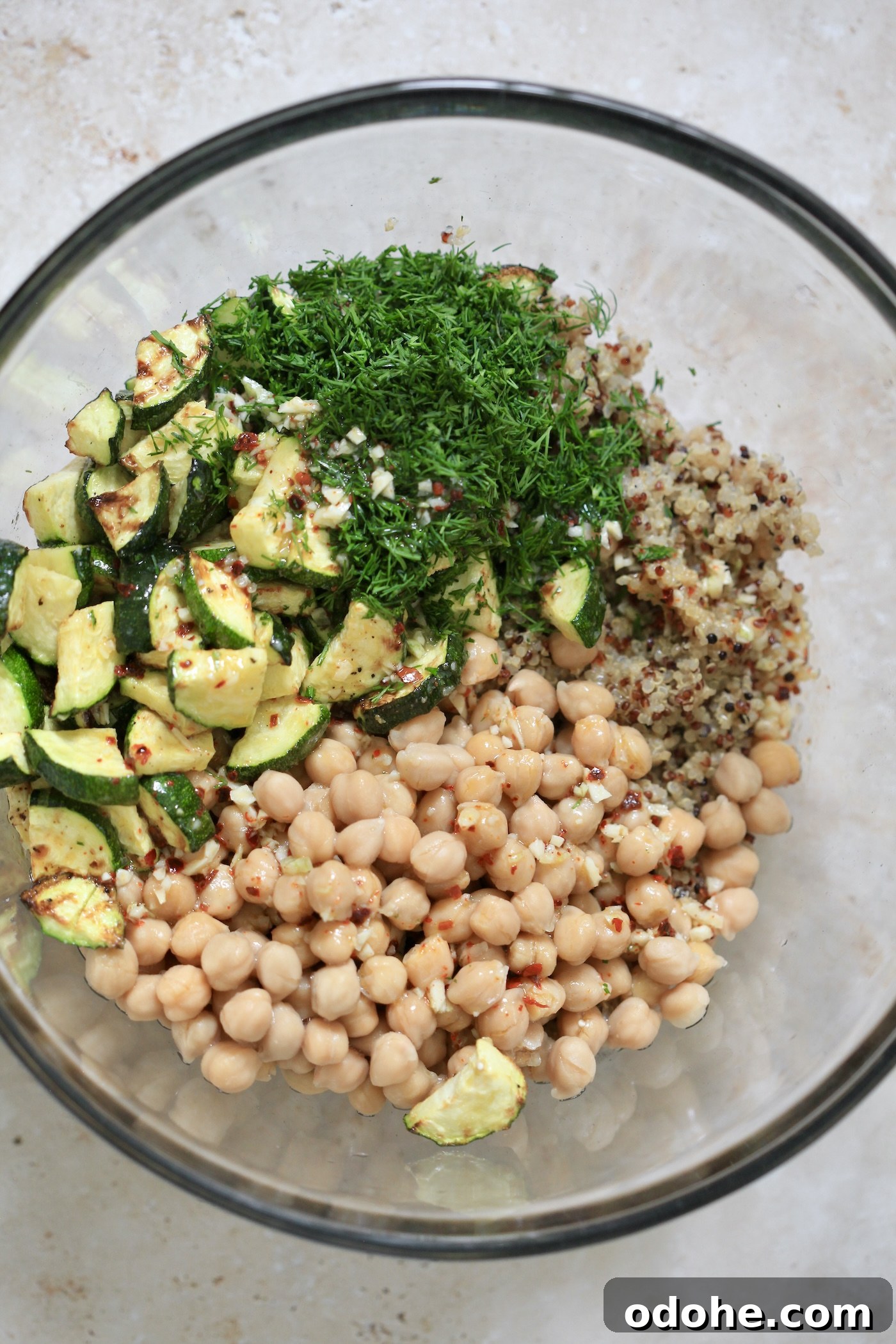 Zucchini, Quinoa & Chickpea Salad with Feta and Fresh Dill 6 chickpeas, zucchini and dill in bowl.