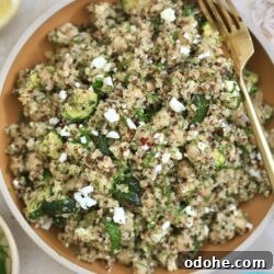 bowl with quinoa salad and feta and gold fork
