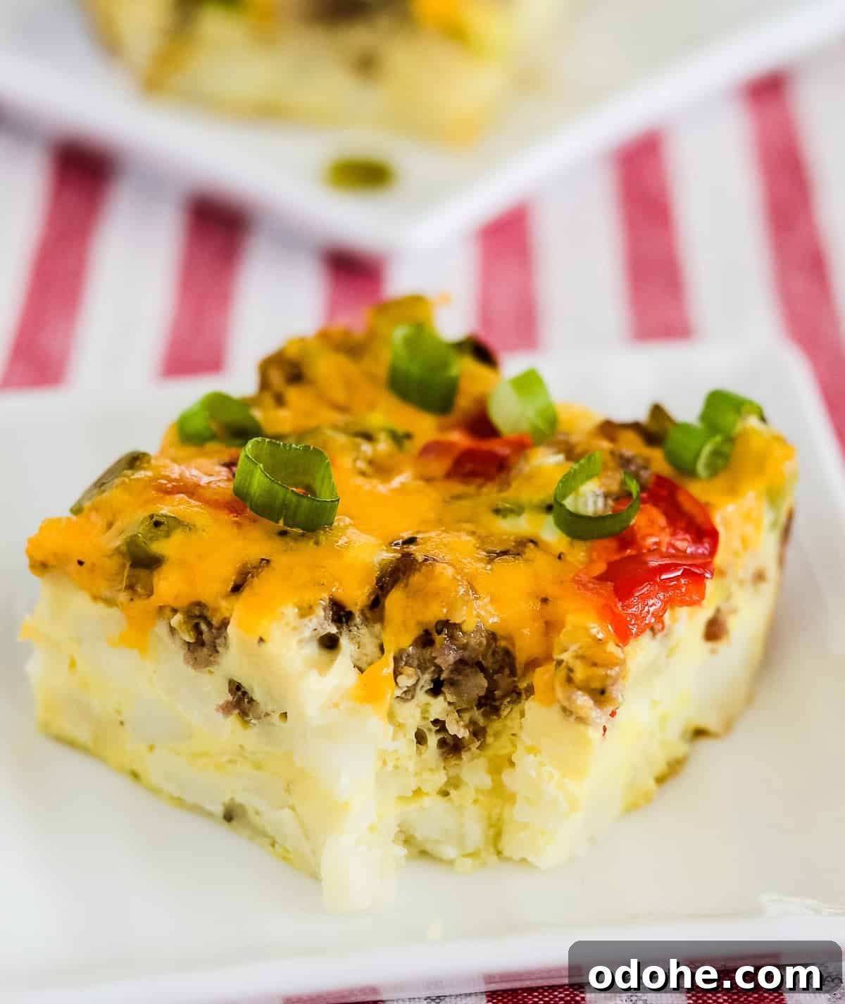 Sausage and Hashbrown Breakfast Casserole Recipe for Mornings 7 slice of sausage hashbrown breakfast casserole on a white plate