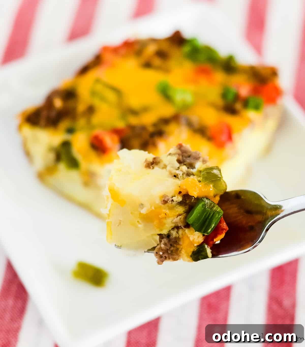 Sausage and Hashbrown Breakfast Casserole Recipe for Mornings 8 bite of breakfast casserole on a fork