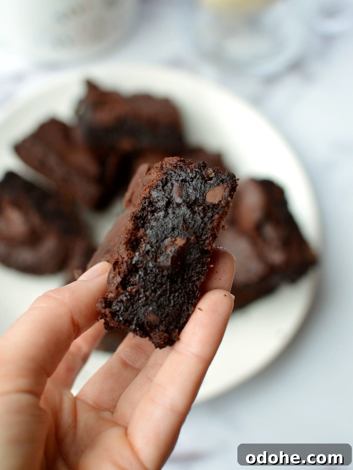 Fudgy Almond Flour Brownies Recipe — Gluten-Free Chocolate Treat 9 hand holding a brownie