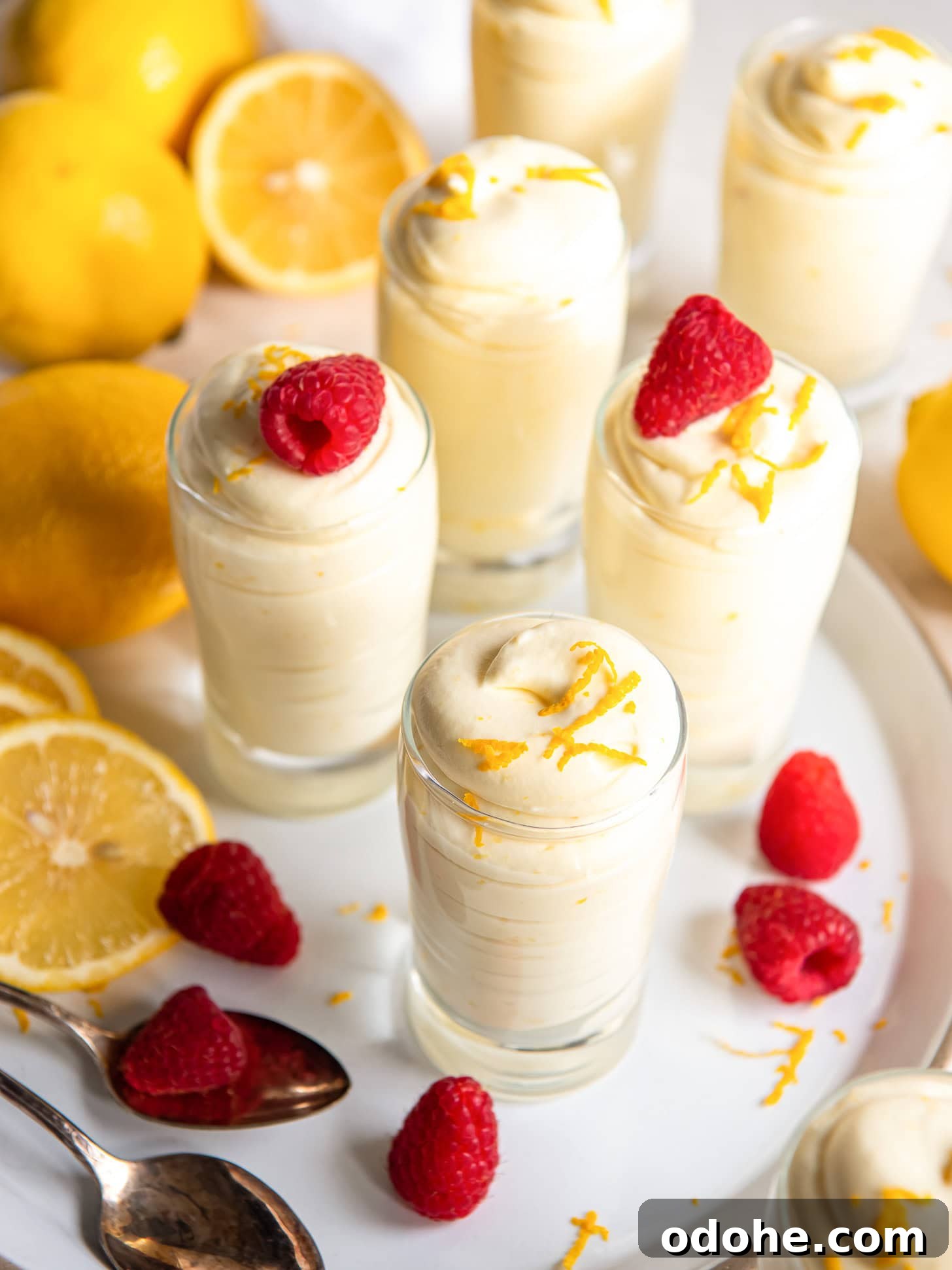 Homemade Lemon Mousse Recipe: Light, Zesty, from Scratch 6 Lemon mousse in small individual glasses served with raspberries.
