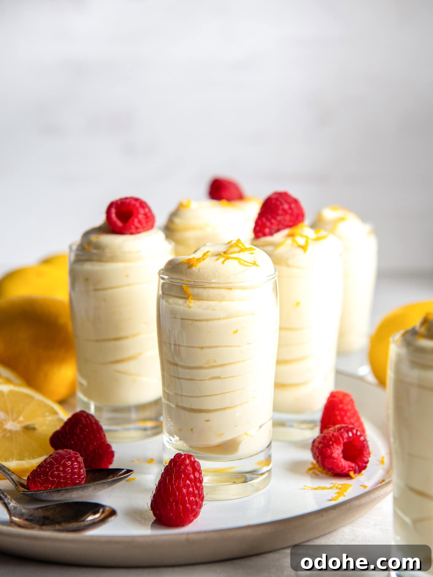 Homemade Lemon Mousse Recipe: Light, Zesty, from Scratch 7 Lemon mouse topped with fresh raspberries.
