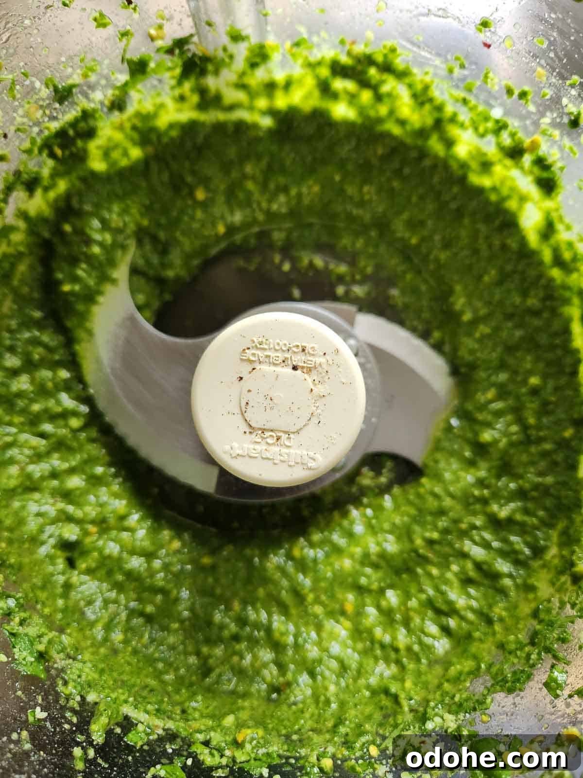 Roasted Garlic Pesto Sauce Recipe for Rich, Creamy Flavor 7 Pesto blended in a food processor.