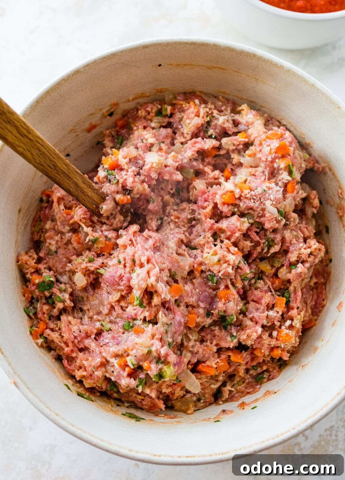 mix all the ingredients for Italian meatloaf in a bowl until fully combined.