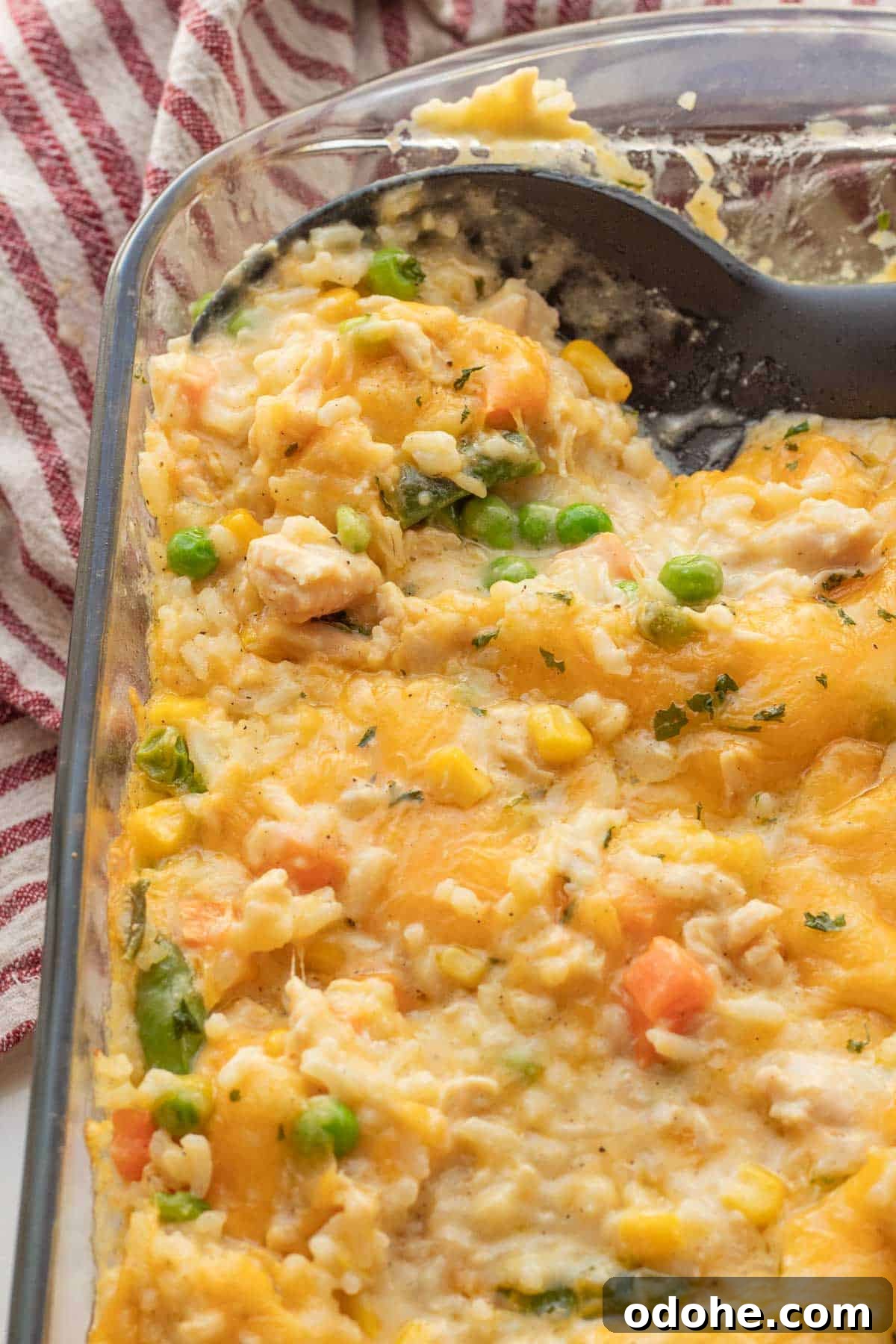 Cheesy Chicken, Rice & Veggie Casserole Recipe 2 Baked Chicken and rice casserole in glass baking dish.