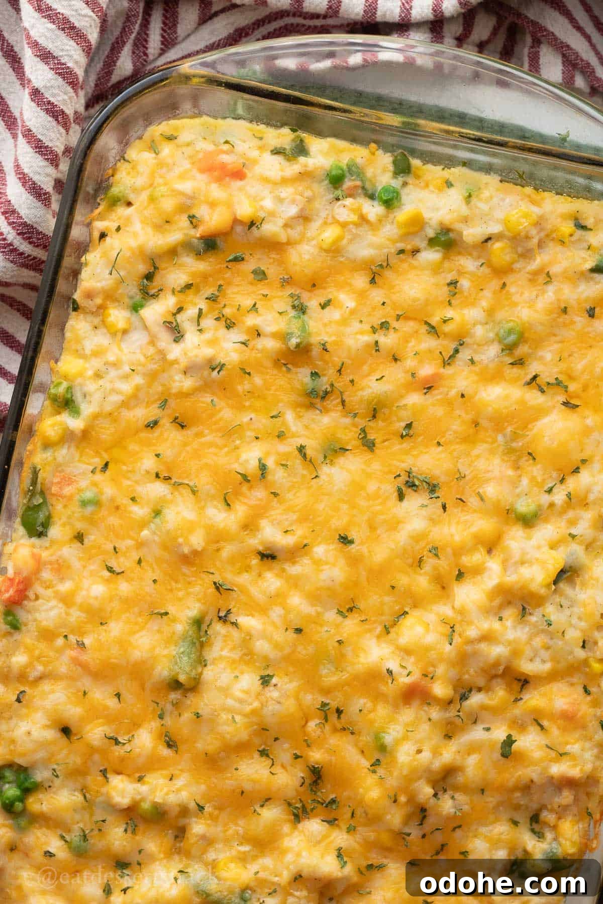 Cheesy Chicken, Rice & Veggie Casserole Recipe 11 Baked chicken rice veggie casserole in glass baking dish.