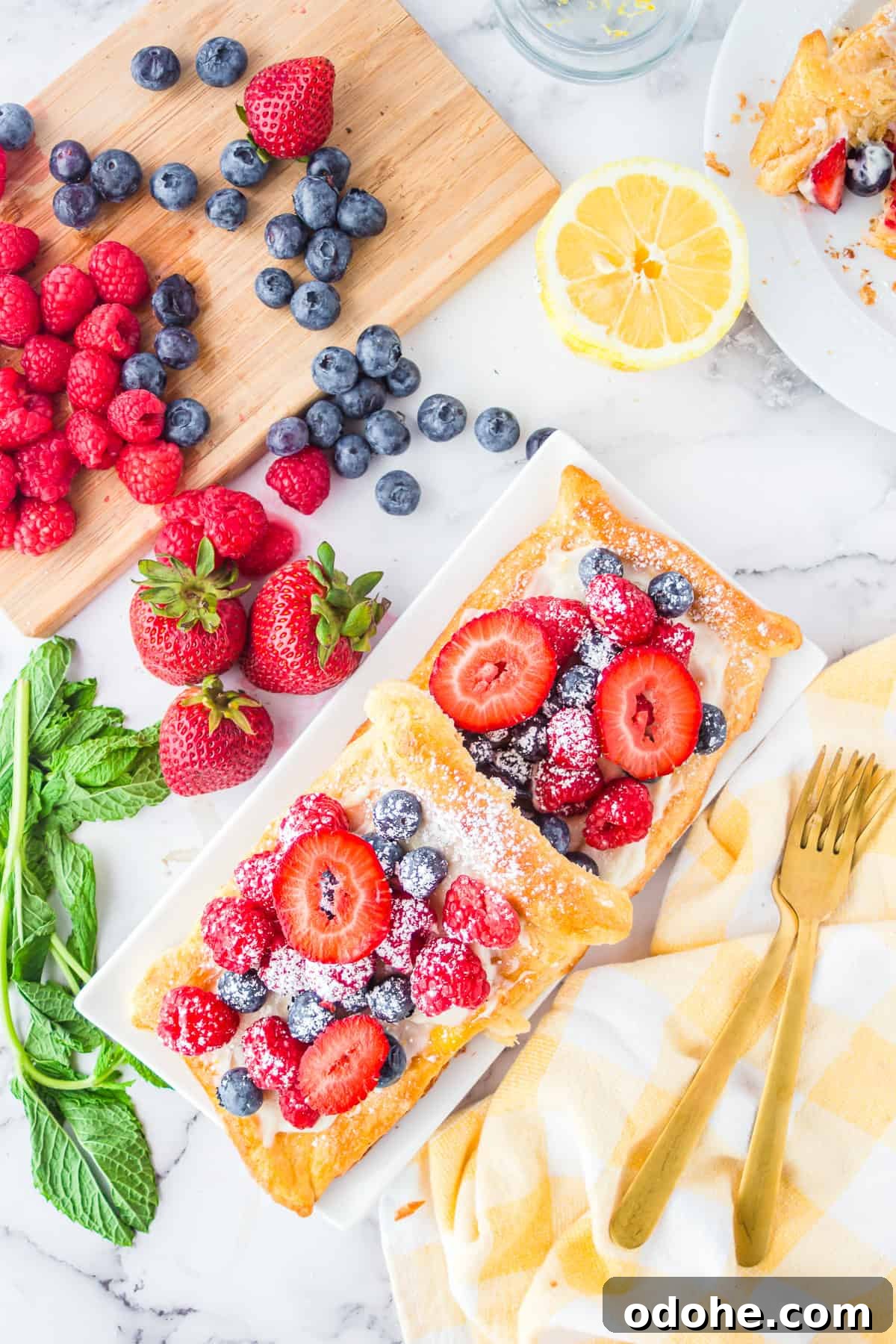 Crescent Dough Berry Tart: Quick Recipe for Flaky Fruit Tarts 3 Overhead of two stacked Berry Tarts with fruit surrounding tarts