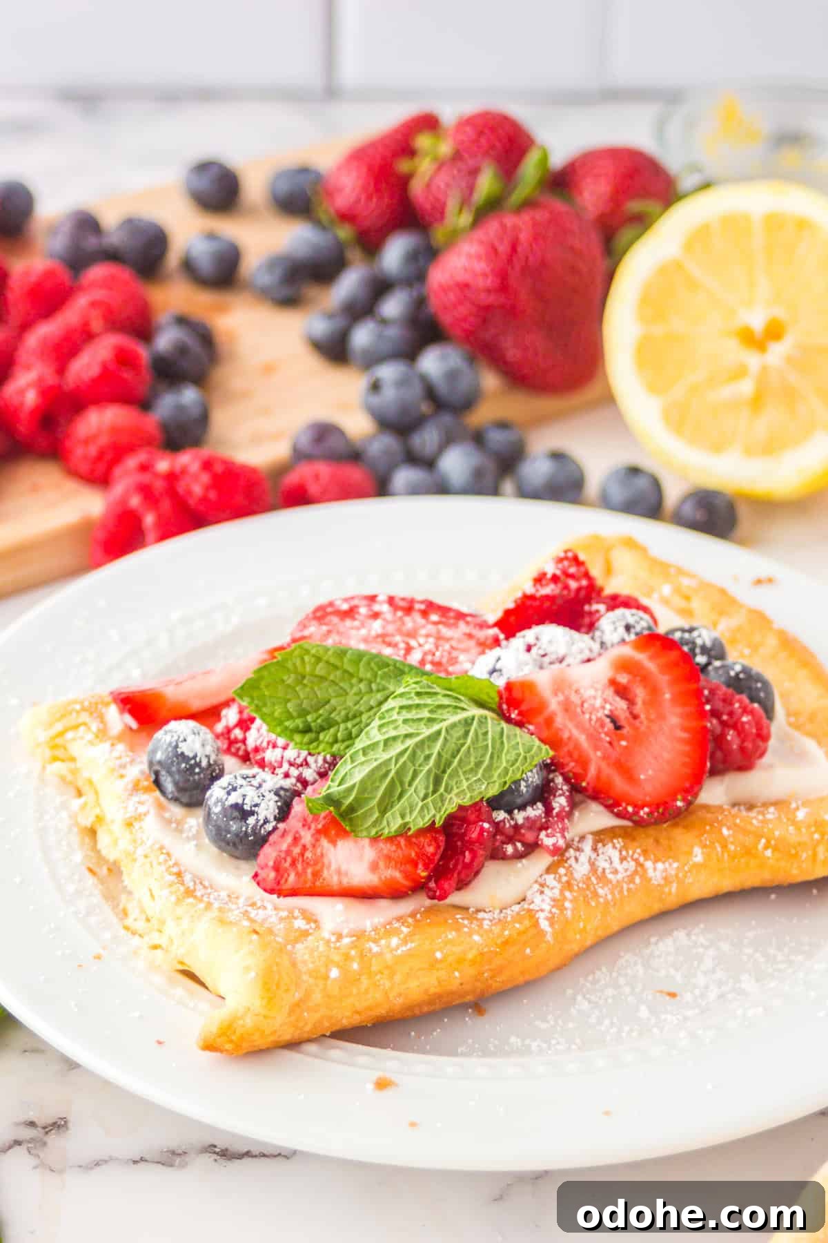 Crescent Dough Berry Tart: Quick Recipe for Flaky Fruit Tarts 6 Berry Tart on plate with fruit in background