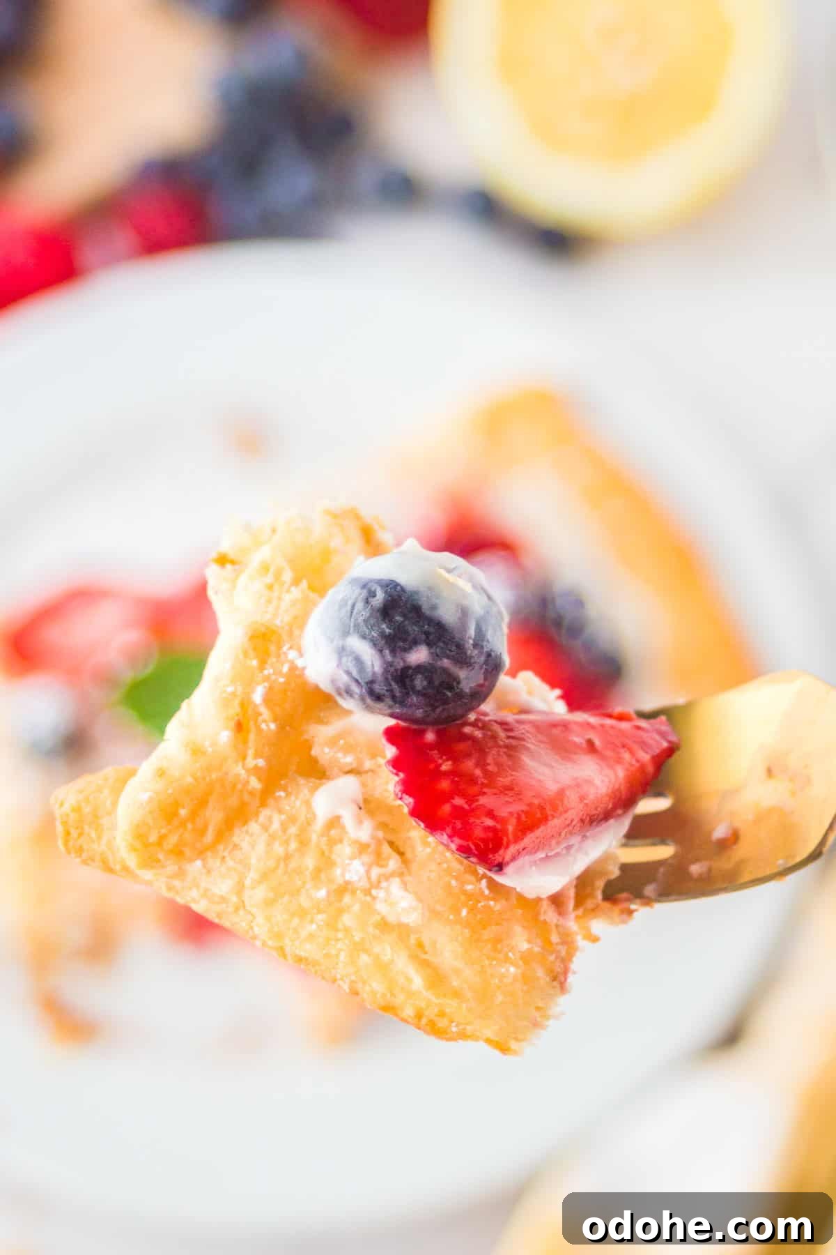 Crescent Dough Berry Tart: Quick Recipe for Flaky Fruit Tarts 7 Fork holding up a bite of the tart