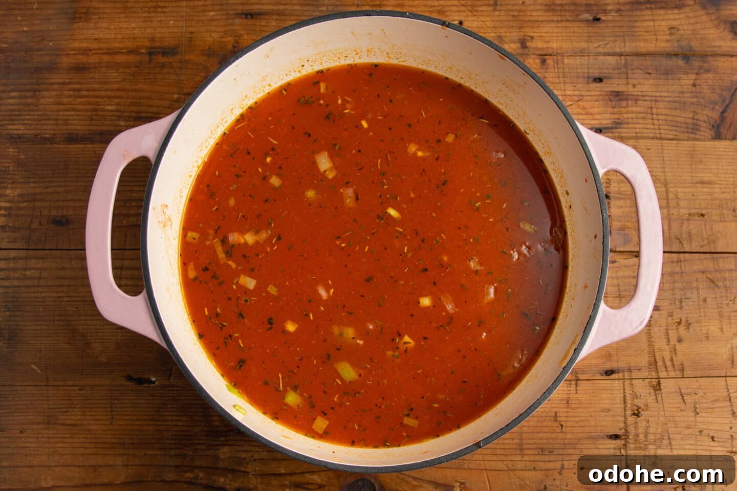 This is a picture of the pot with the tomatoes and broth added.