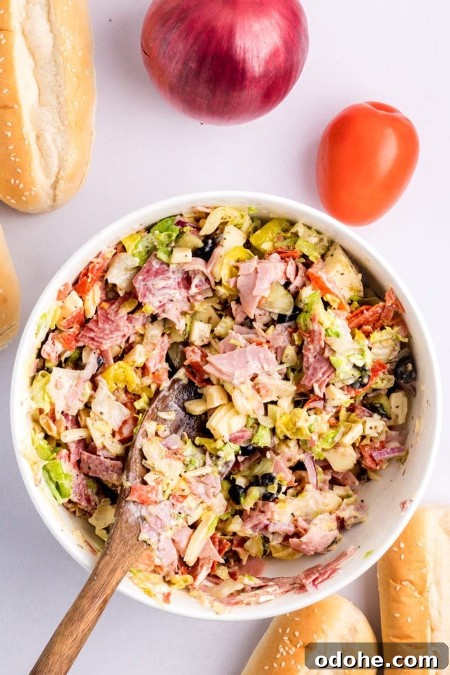 Crispy Chopped Italian Sandwich + Fix for Soggy Buns 8 mixing Chopped Italian Sandwich ingredients with homemade dressing