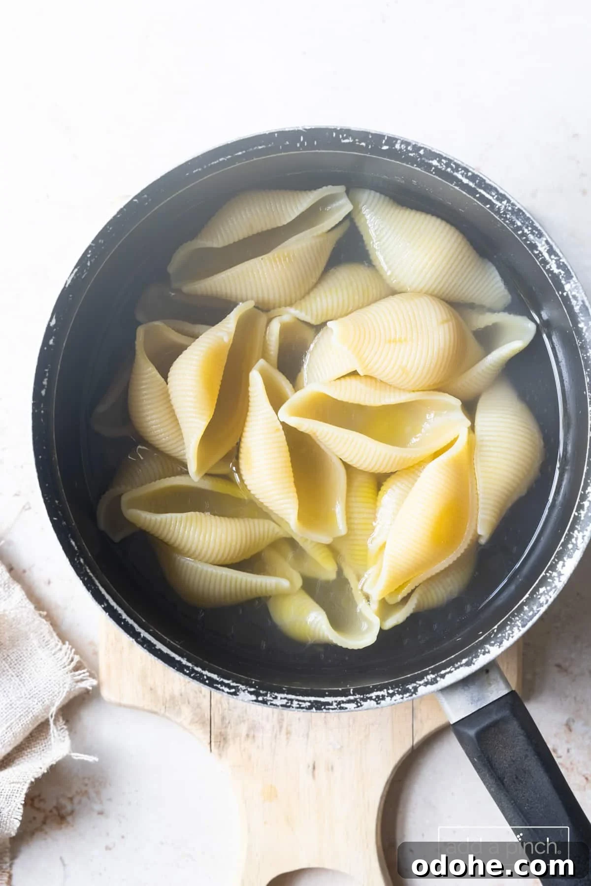 Photo of cooked pasta shells in a pot.