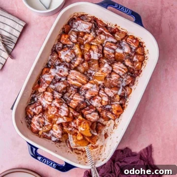 cinnamon roll with apple pie drizzled with creamy glaze.