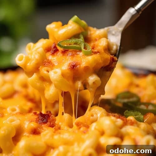 Spicy Pimento Mac and Cheese with Crispy Panko Topping 7 a pan of Spicy Pimento Mac & Cheese with Panko with a spoon