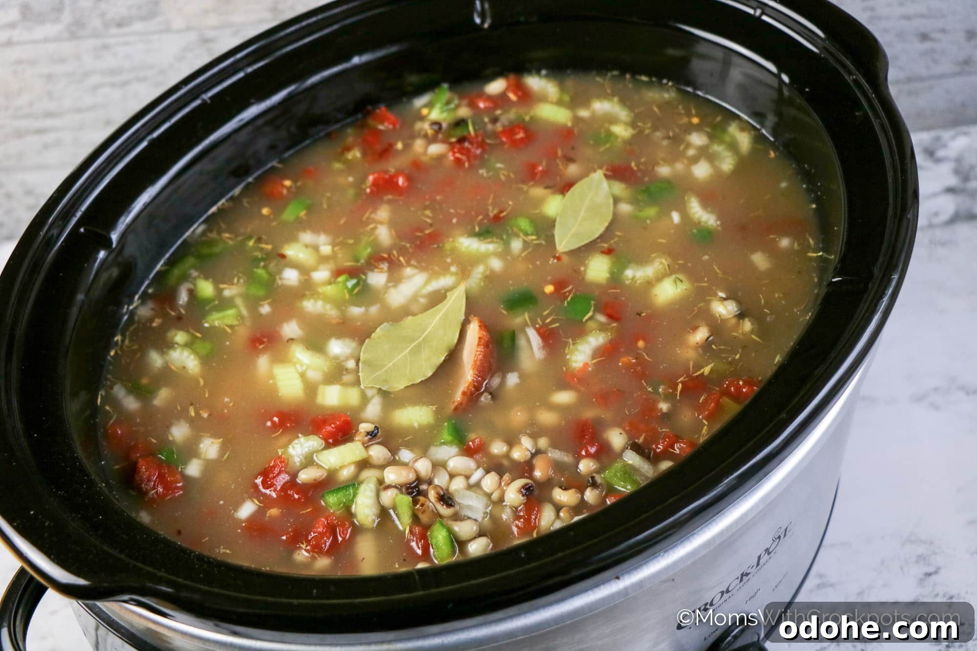 Slow Cooker Hoppin' John Recipe — Classic Southern Black-Eyed Peas 5 Crockpot with hoppin John uncooked and bay leaves