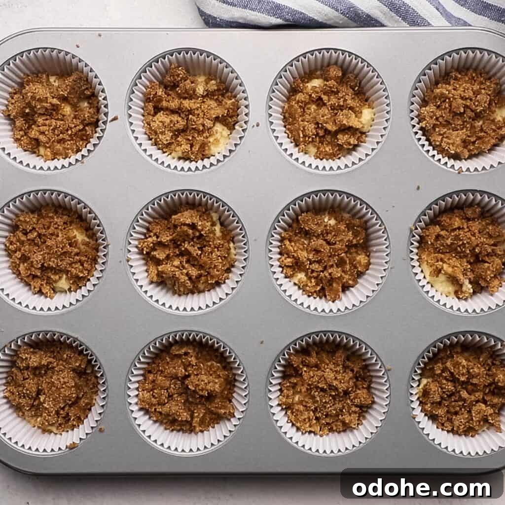 A layer of muffin filling on top of batter in a muffin tin.