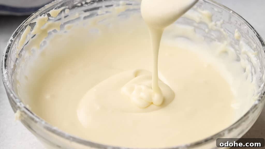 Cream cheese glaze for muffins in a bowl.