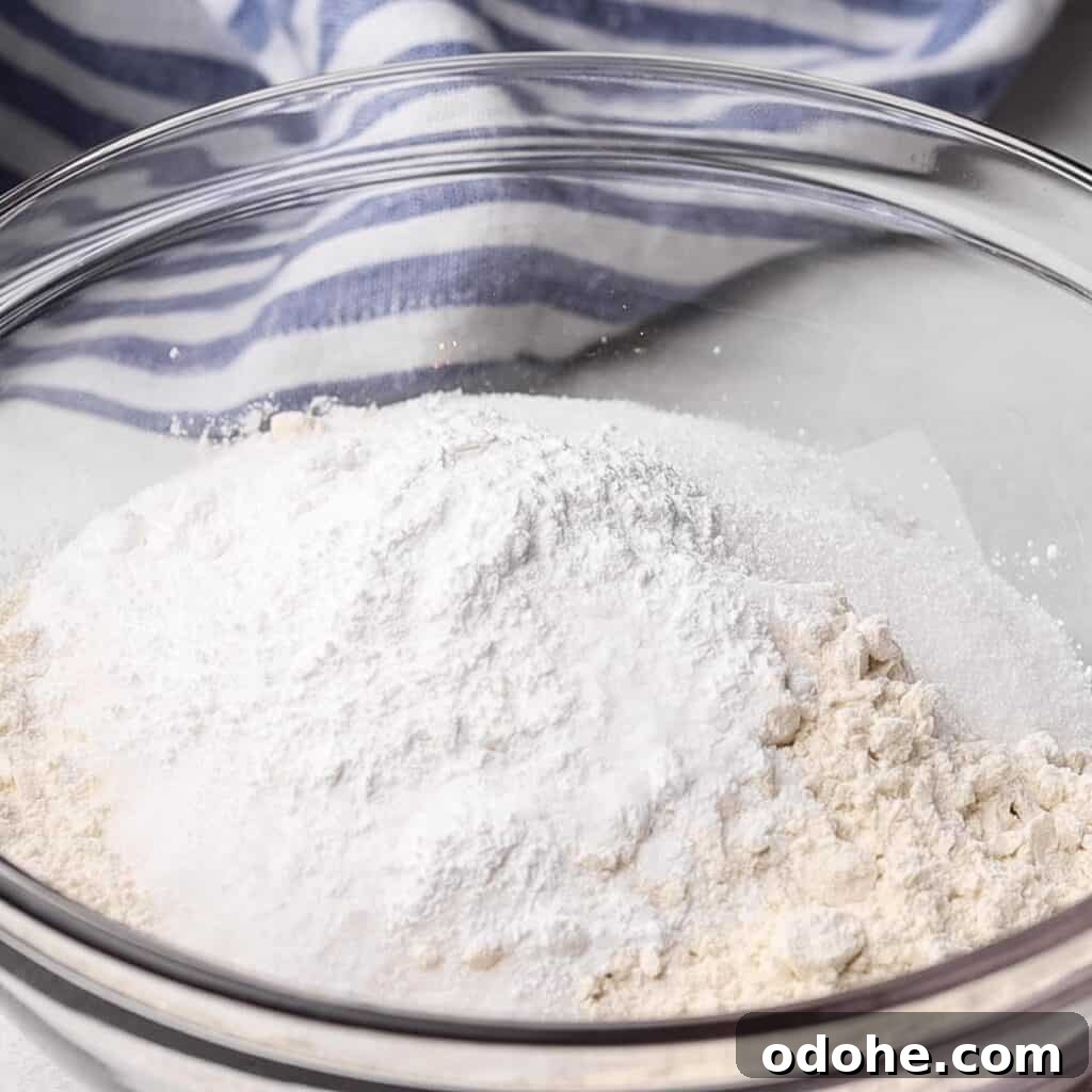 Flour, sugar, baking powder, and salt in a bowl.
