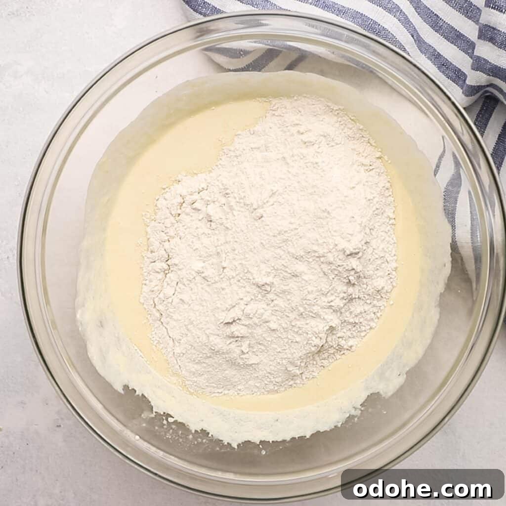 dry ingredients being added to wet ingredients for muffin batter.