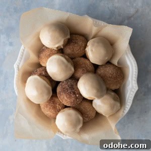 Baked donut holes in a bowl with parchment paper.