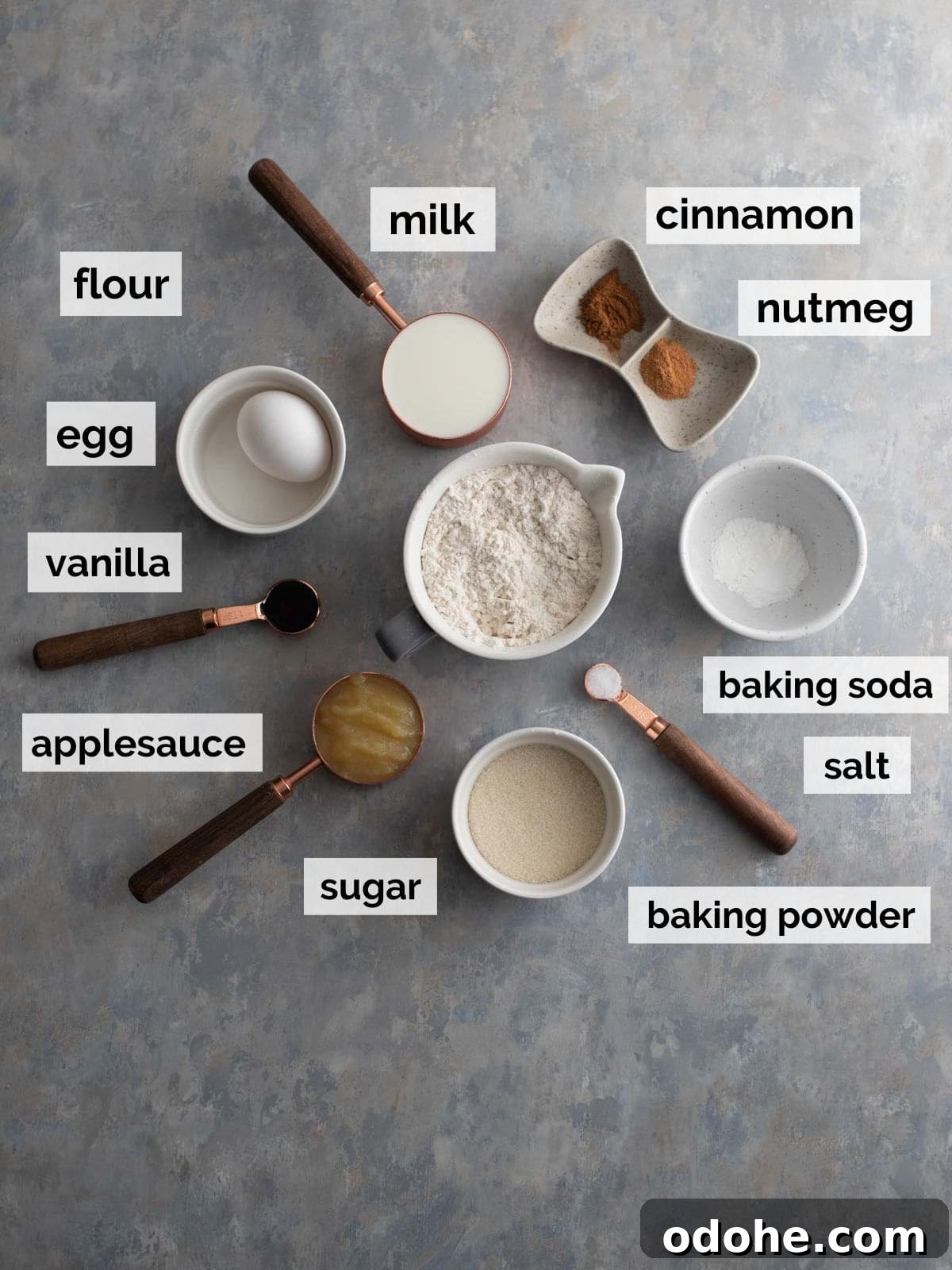 Flour, sugar, milk, and donut ingredients on a table.
