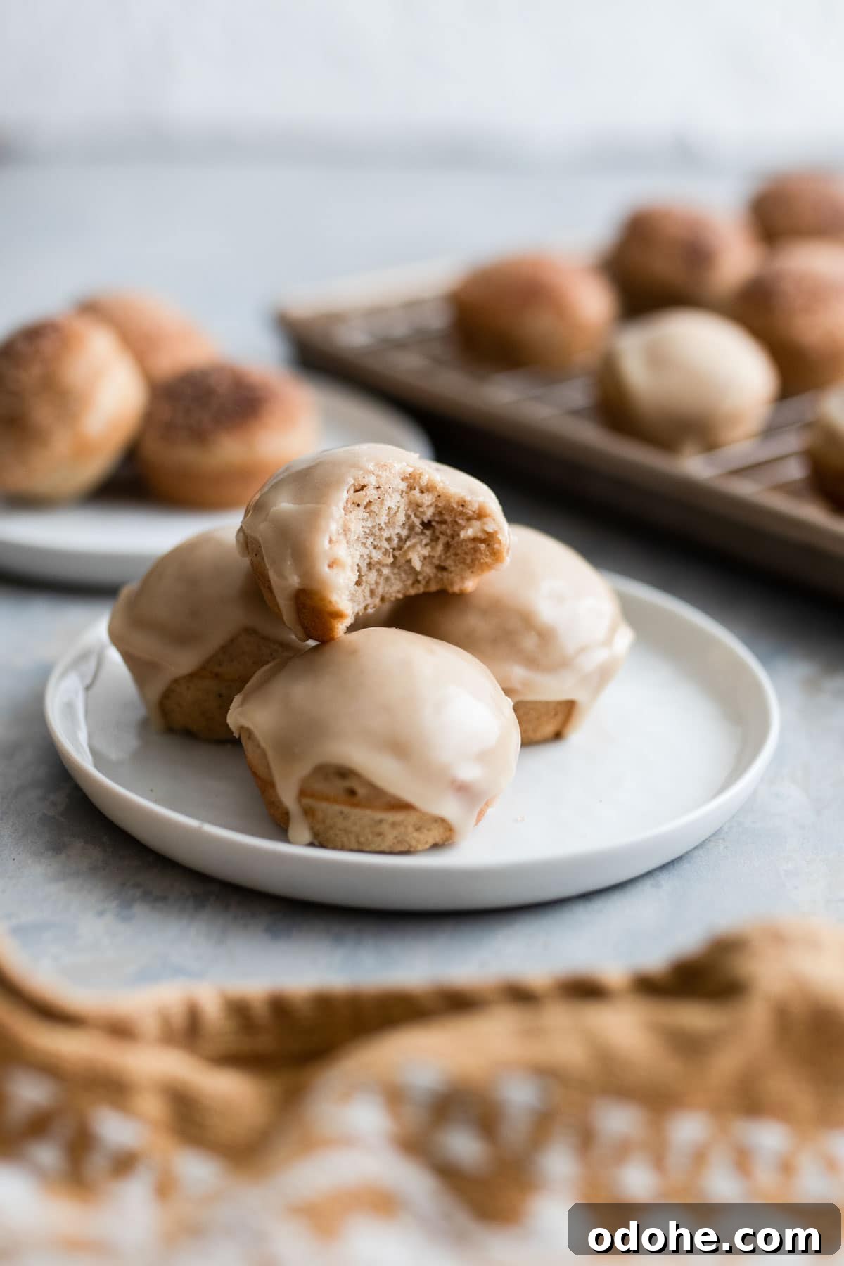 A bite out of a glazed donut hole.