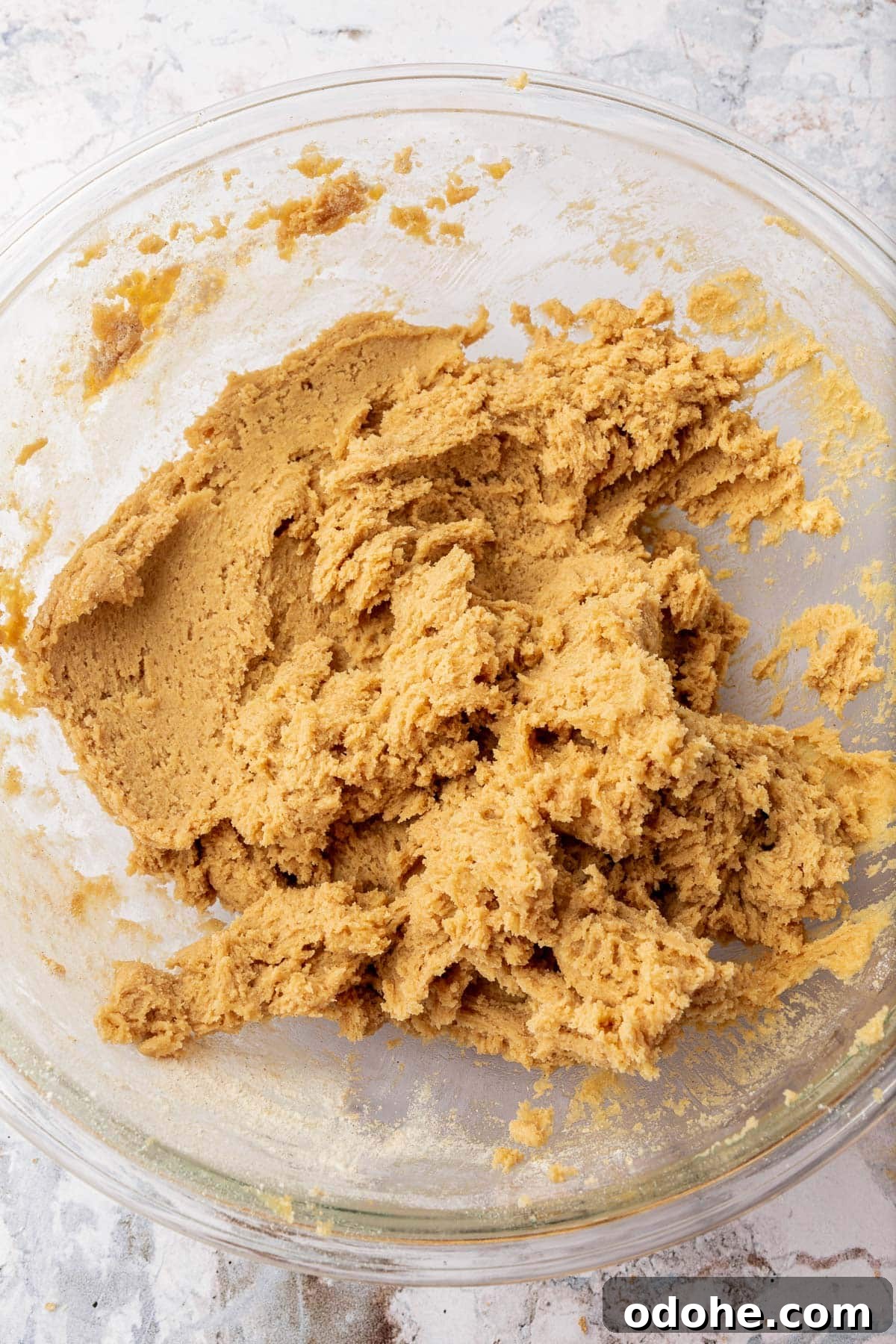 Gluten-Free Snickerdoodle Cookies Recipe: Soft, Cinnamon-Sugar Treats 8 A glass mixing bowl with gluten-free snickerdoodle cookie dough in it.