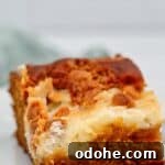 slice of gluten free pumpkin earthquake cake on white plate.