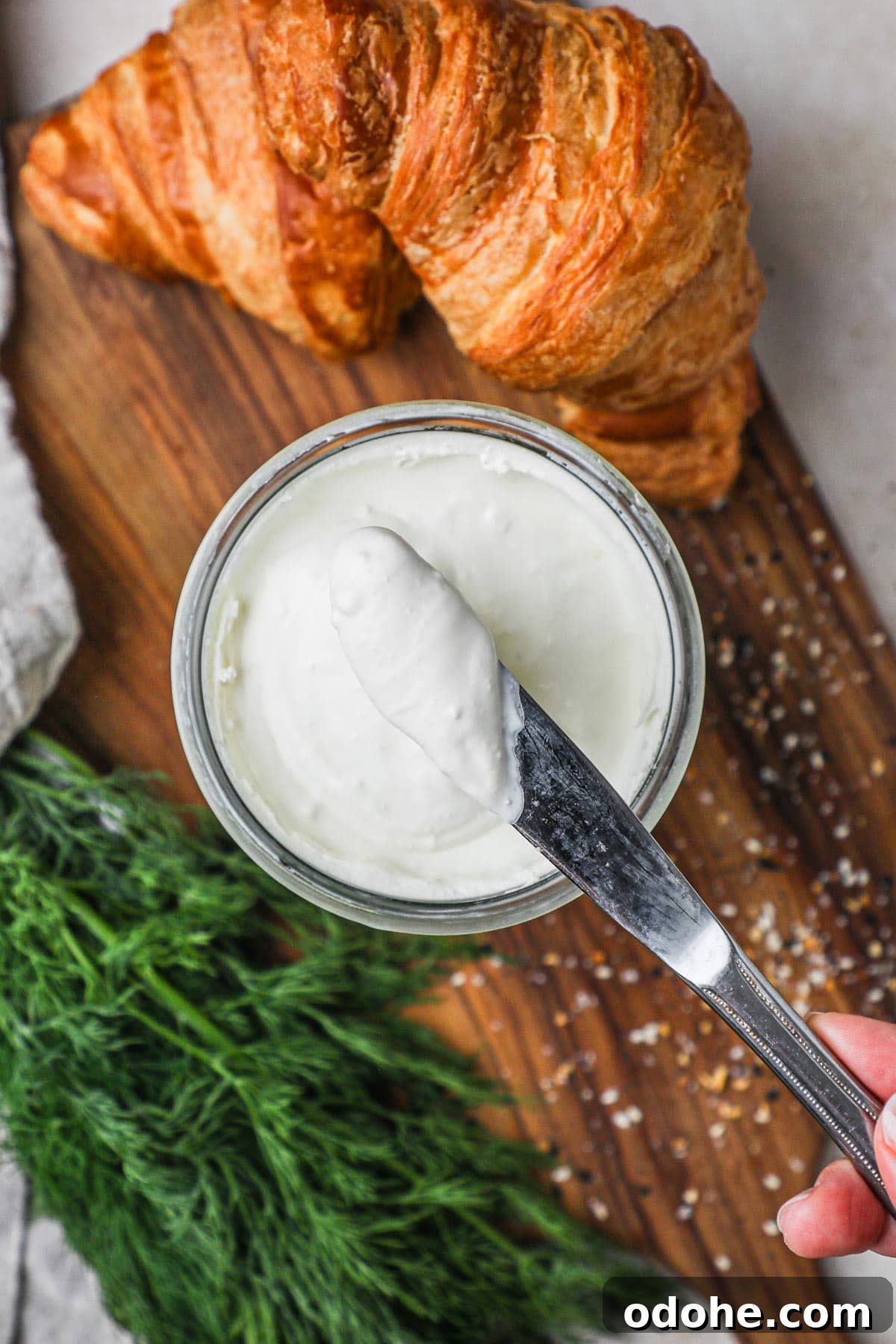 Homemade Cream Cheese: Simple Recipe for Smooth, Tangy Spread 2 Knife with a scoop of homemade 2-ingredient cream cheese, used for cheesecake, bagel, toast, and more.