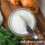 Homemade Cream Cheese: Simple Recipe for Smooth, Tangy Spread 10 Knife with a scoop of homemade 2-ingredient cream cheese, used for cheesecake, bagel, toast, and more.