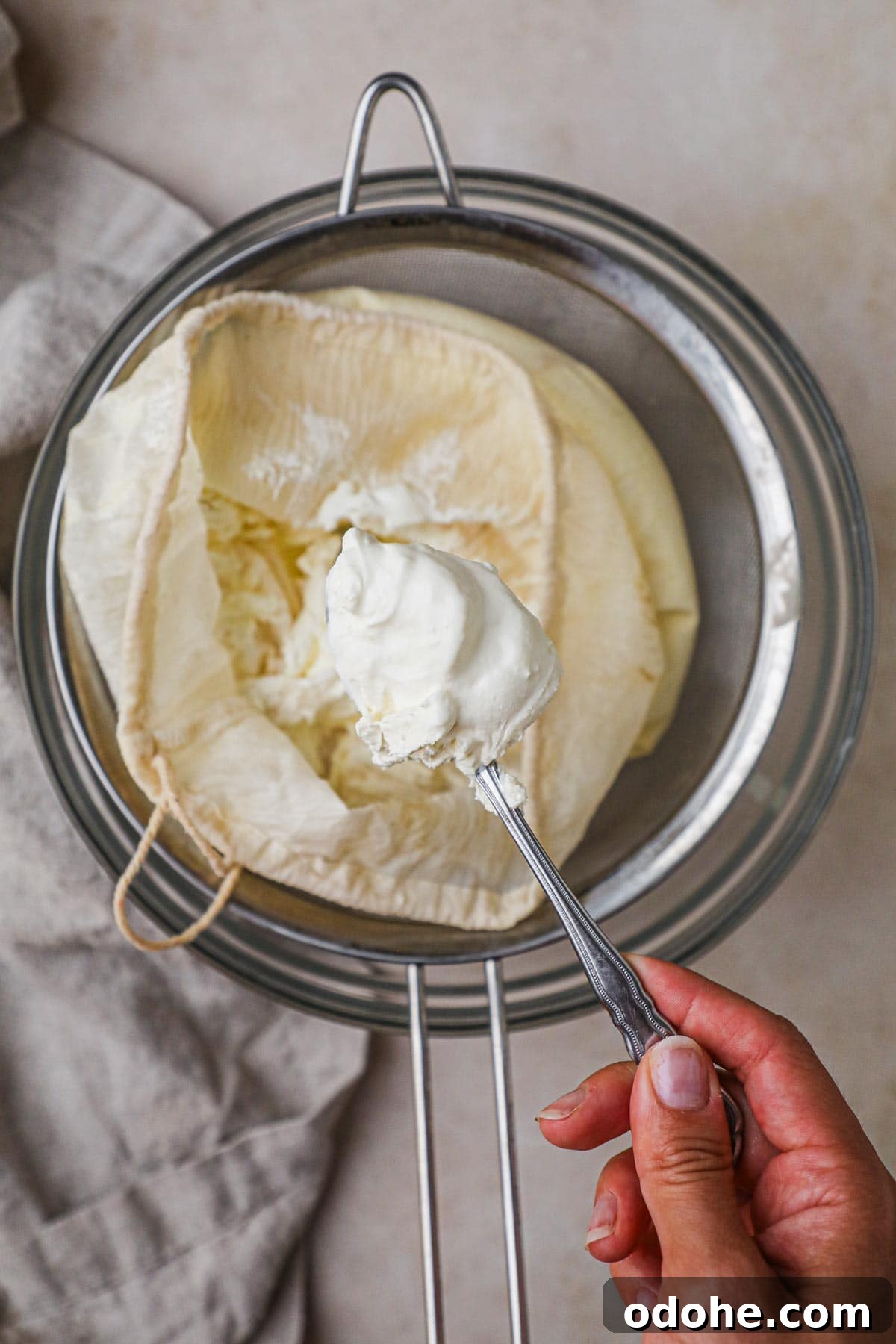 Homemade Cream Cheese: Simple Recipe for Smooth, Tangy Spread 5 Homemade cream cheese on a spoon that can be used for cheesecake, bagels, toast, and more.