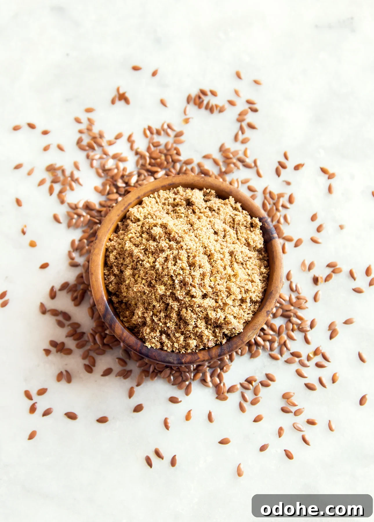 Whole and ground flax seeds on marble background // FoodNouveau.com